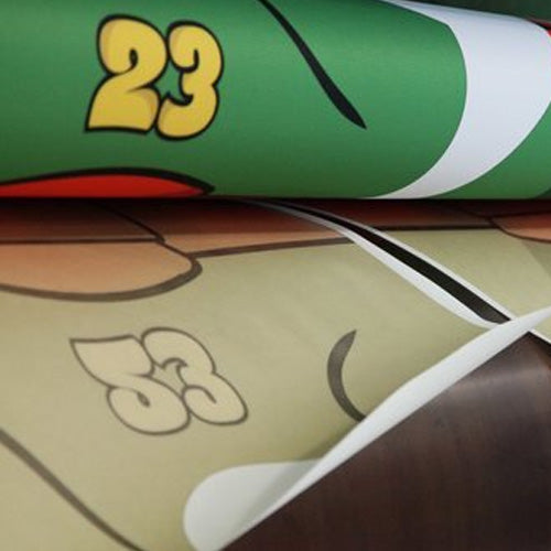 Close up of sublimation printing on polyester fabric for a basketball jersey in green, gold, orange, black 